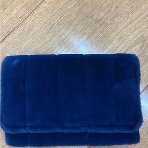 A New Day faux fur blue clutch with retractable wrist handle
